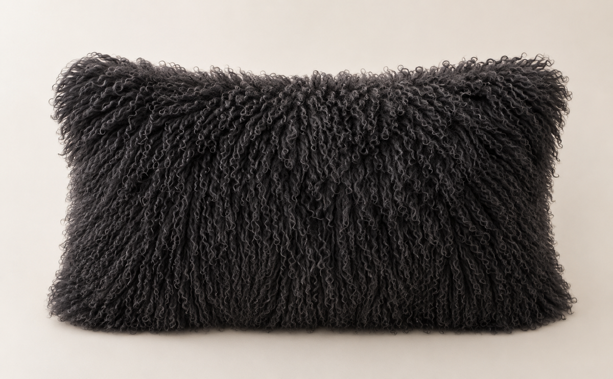 Black rectangular Mongolian sheepskin cushion viewed from the front