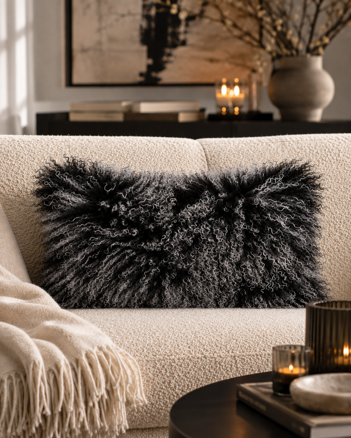 Black Snow Top Mongolian sheepskin cushion 12 x 20 inch on a cream sofa