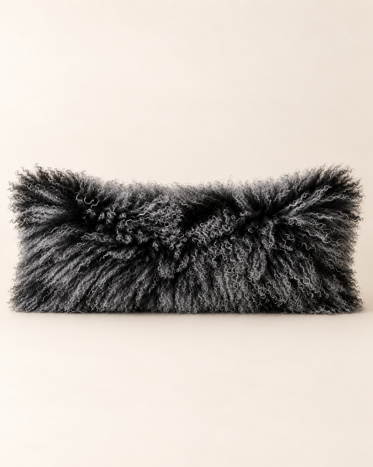 Black Snow Top Mongolian sheepskin cushion 12 x 32 inch studio product shot