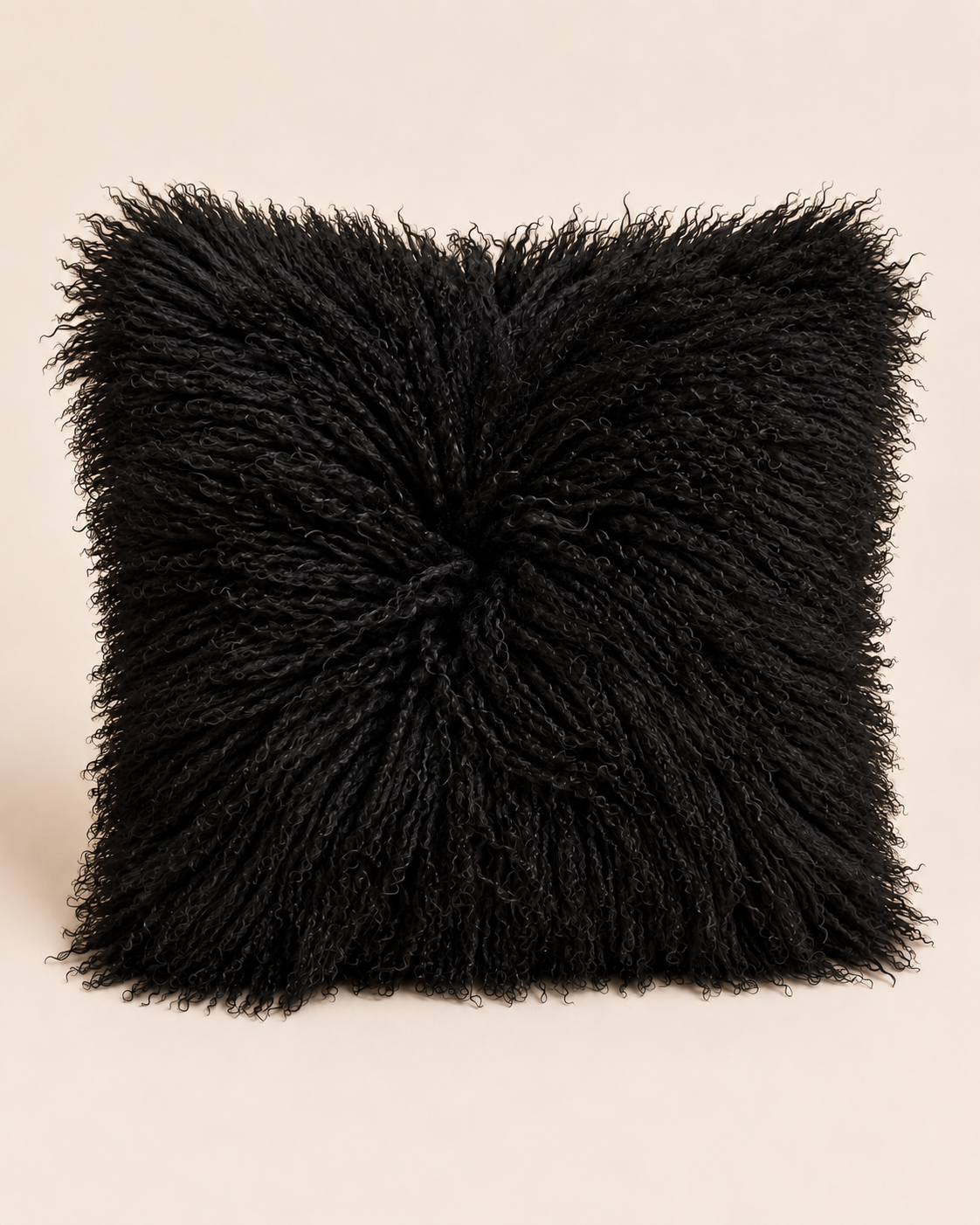 Black square Mongolian sheepskin cushion on a beige background